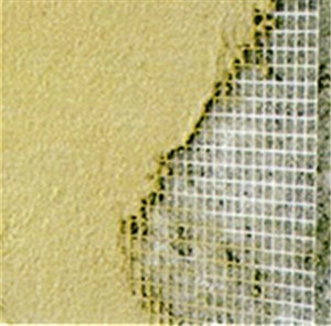 A reinforcing mesh which is made from woven fibreglass yarns and coated with an alkaline resistant latex. This coating prevents the alkaline present in cements from degrading the glass fibre, resulting